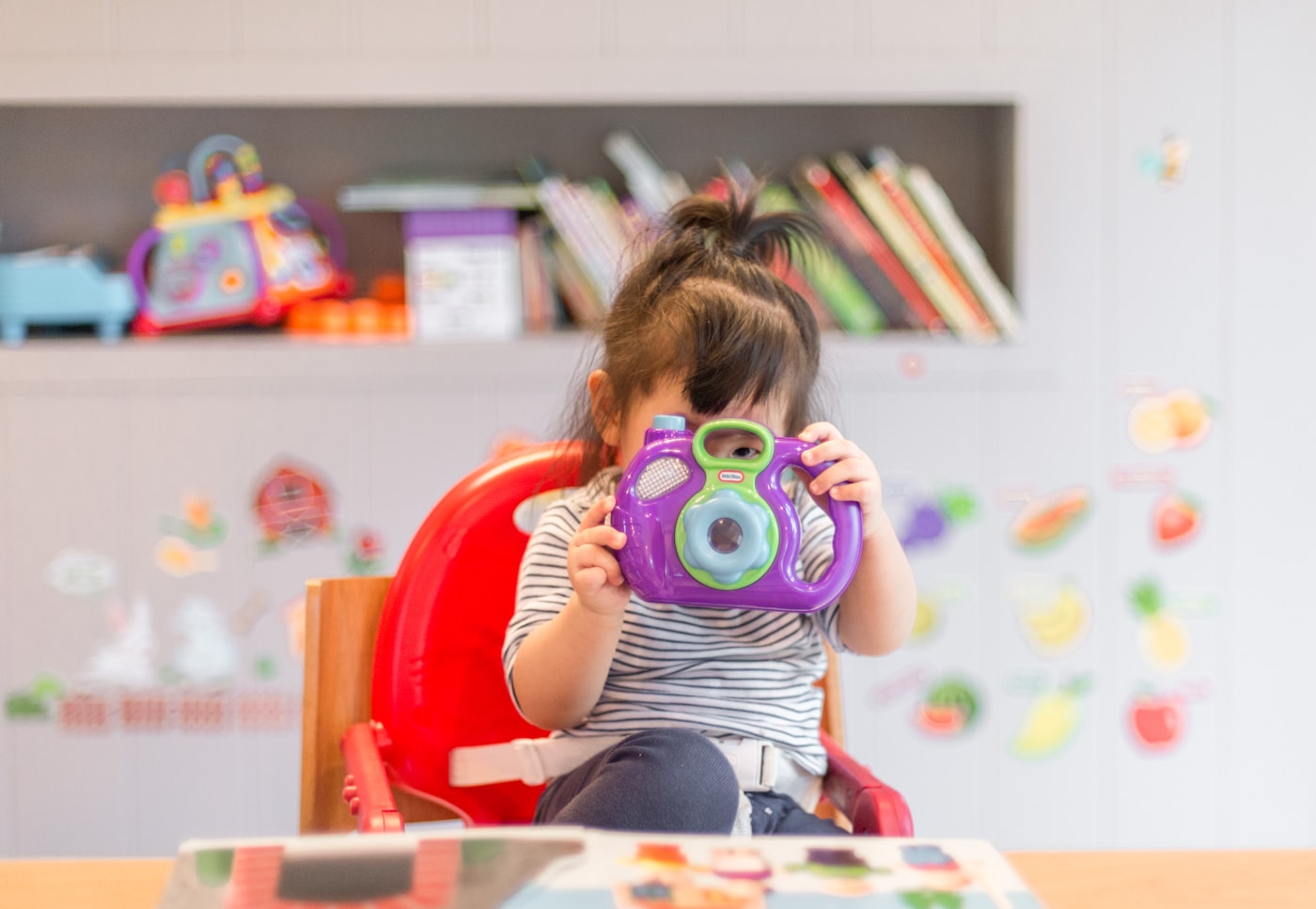 A toddler exploring through play